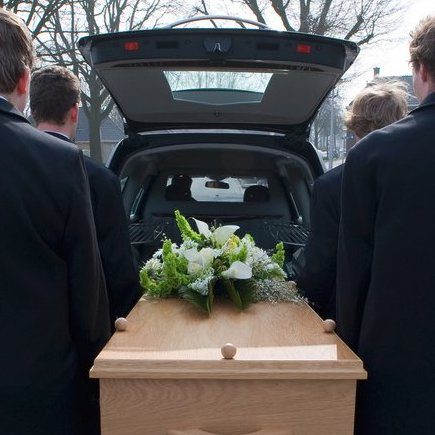 agent funeraire portant un cercueil
